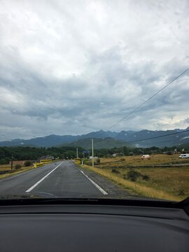 Driver POV of a road crossing Paraul Laita river towards Fagaras mountains, Romania