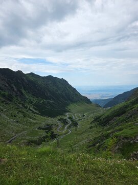 Winding Transfagarasan mountain highway twisting through a deep valley in Romania