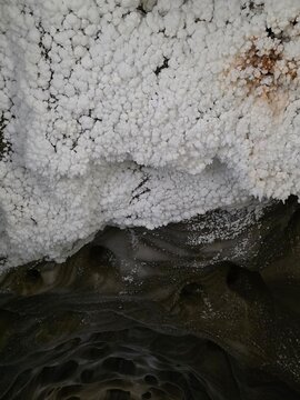 White salt crystals and stalactites inside the historic Turda salt mine, Romania