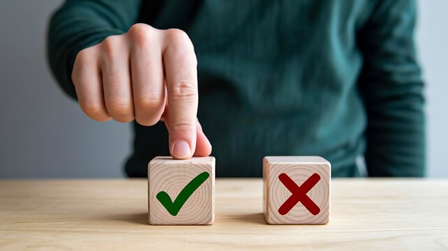 Hand choosing a correct decision with green checkmark and red cross blocks