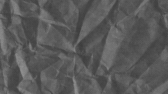Black crumpled paper surface with vintage halftone texture moving effect