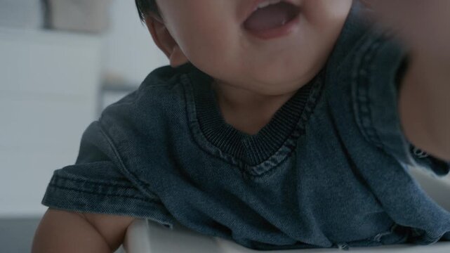 Cute Asian baby boy smiling happily and reaching hand towards camera.4K