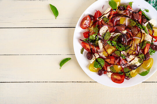 Fresh Mediterranean Salad with Feta, Basil and Balsamic Dressing. Top view