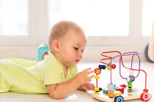 Baby Boy Reaches For Beads On Educational Maze Toy