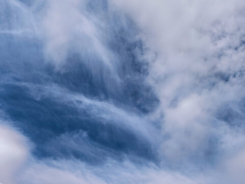 Dramatic Layered Clouds Over Open Blue Horizon