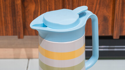 Plastic pitcher stands on a counter. © Bima