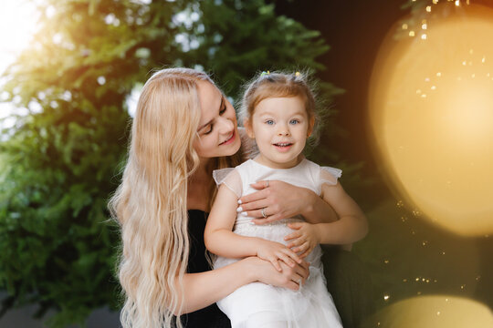 Mother and daughter celebrating new year together in festive setting, bokeh light