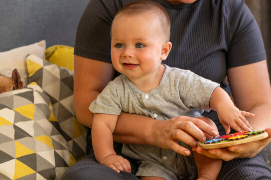 Smiling Baby Learning Through Play With Caregiver Indoors
