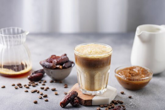 Iced coffee dates latte cup. Alternative trendy vegan drink
