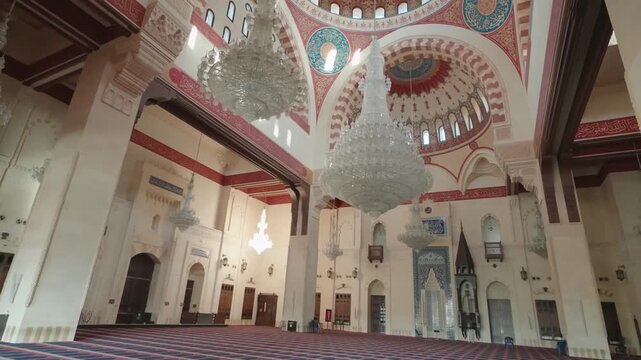 grand mosque interior hall with massive crystal chandeliers