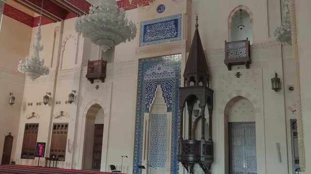 mosque interior showing blue tile mihrab and wooden minbar