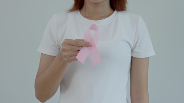 Woman hold pink ribbon breast cancer awareness. Female health check consciousness. international Women Day and World Cancer Day. sign cancer, Symbolic, health care, support patients, timely diagnosis