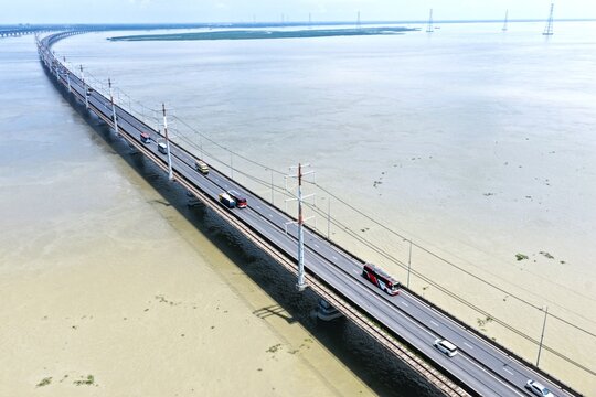 Aerial view of Jamuna Bridge spanning the wide Jamuna River with vehicles traveling across the multi-lane highway in Tangail District, Dhaka Division, Bangladesh.