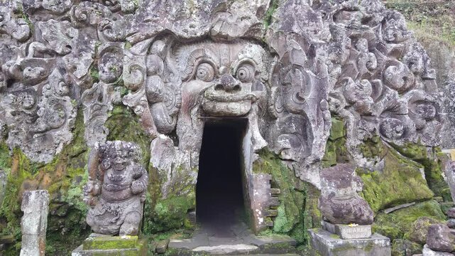 Establishing of Cave Entrance in Historic Carved Stone Face Sanctuary Goa Gajah Temple Bedulu Bali Indonesia