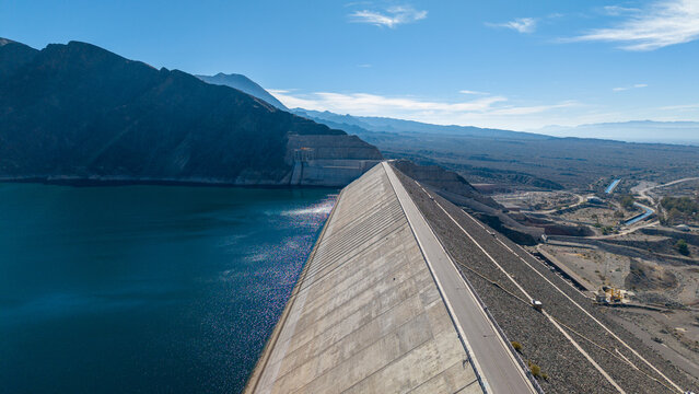 Aerial view of Dique Punta Negra dam and its reservoir surrounded by arid mountains and desert landscape in Zonda Department, San Juan Province, Argentina.