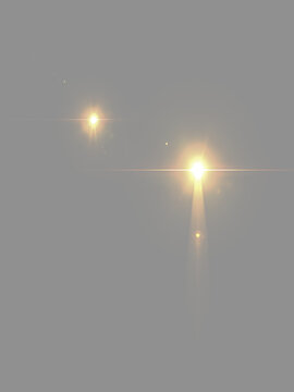 Abstract glowing golden lens flare lights isolated on grey background. Bright gold starburst light effect overlay. Luminous warm lighting flashes with optical flare effect