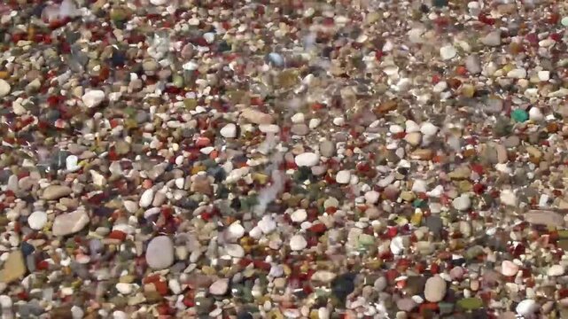 Colorful Mediterranean pebbles beach with gentle waves closeup Bar Montenegro.