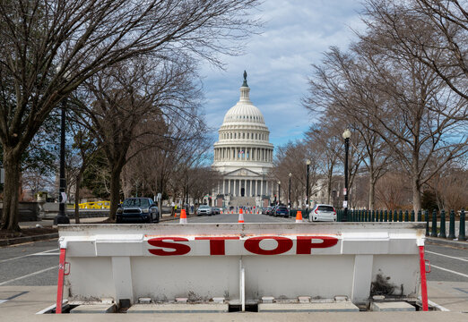 Stop barrier restricting access near Capitol. Government shutdown crisis at Capitol Hill. Political tension in Washington DC government. Federal budget stalemate problem.
