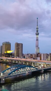 Cityscape of Tokyo skyline, timelapse video of office building at Sumida river in Tokyo in the evening. Japan, Asia.