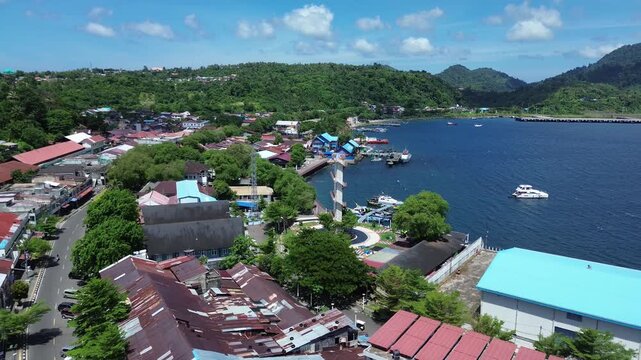 Aerial Landscape of Sabang City with Coastal Harbor and Mountainous Background