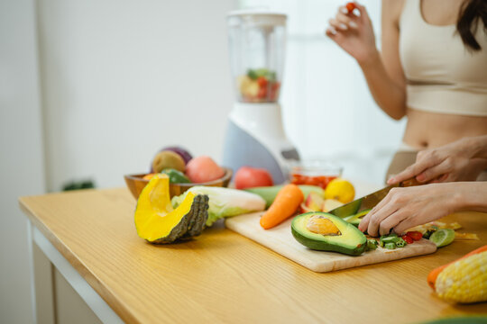 avocado healthy nutrition with vegetables cooking; hands preparing. avocado guides buyer choices, healthy frames the scene, and nutrition adds useful meaning. With focused context.
