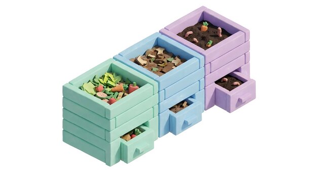 Miniature composting system model with colorful waste bins for eco-friendly recycling demonstration