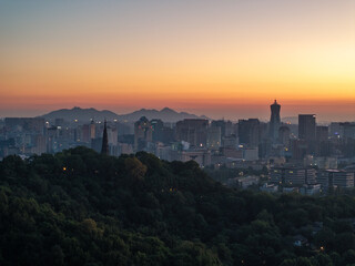 Fototapeta premium city skyline silhouette at dusk with mountains in the background