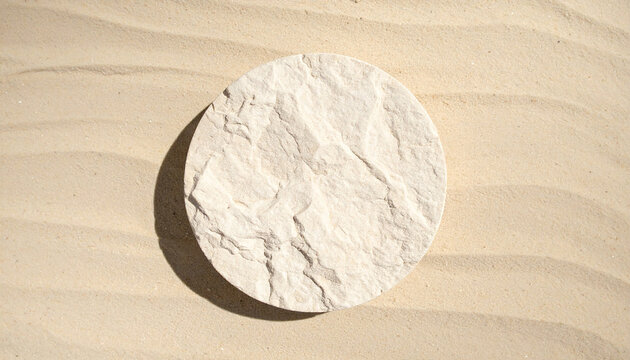 Round natural stone platform resting on warm sandy beach, smooth geometric shape, clean empty surface for product presentation, minimalist coastal composition, flat lay product mock-up.