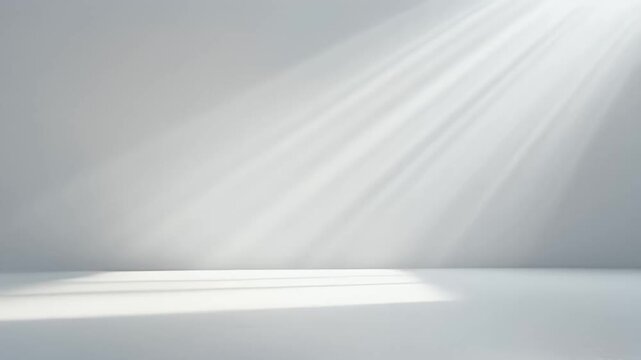Abstract background with soft light rays falling on a clean white wall.