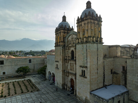 Aerial view of the Church of Santo Domingo de Guzman with its ornate stone facade and twin towers overlooking the courtyard in Oaxaca de Juarez, Oaxaca, Mexico.