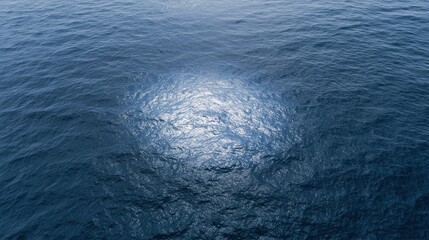 Obraz premium The Sunlit Ocean Surface Reflecting Circular Patch On Deep Blue Water