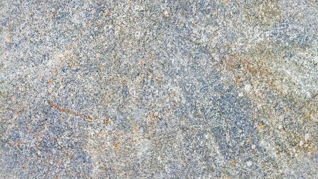 Close-up high-resolution texture of a natural stone or rock surface with a rough, weathered, and highly granular matte finish.  