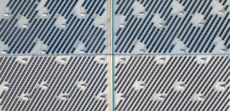 Aerial view of solar panels on a roof of a building, photovoltaic modules, renewable sustainable energy in Trier-Saarburg, Rhineland-Palatinate, Germany.