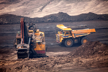Heavy Mining Excavator and Haul Truck Working in Open Pit Mine © William