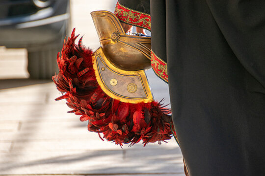 Roman soldier carrying a galea helmet in hand The Concept of ending a parade