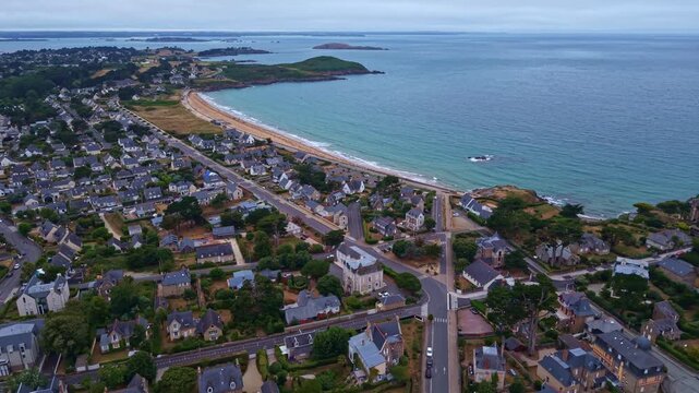 Saint-Lunaire, Longchamp Beach, Pointe du Decolle, Ille-et-Vilaine, Brittany, France, overlooking the English Channel and Emerald Coast with sandy bay, waterfront district and offshore islets aerial