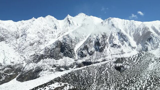 Wide aerial drone panorama showcasing the immense snow-covered alpine ridges and massive glacial ice flows of Rakaposhi Mountain Pakistan