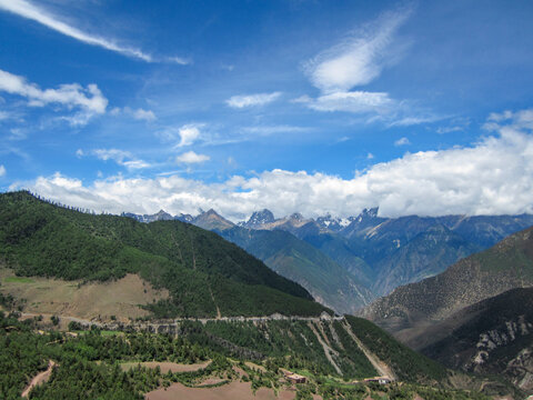 Breathtaking mountain range under blue sky with white clouds