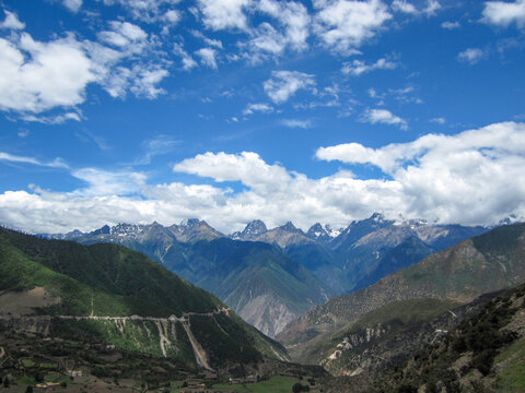 Beautiful mountain range under blue sky with white clouds