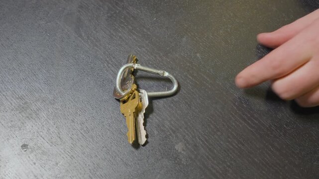 Removing the key fob for a car off of a set of keys.