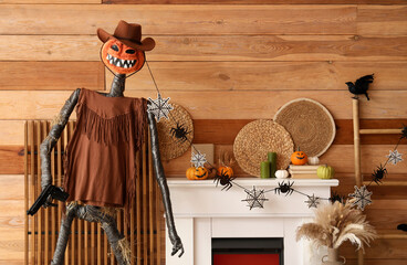 Obraz premium Interior of festive living room with Spooky Halloween monster and autumn decorations on fireplace