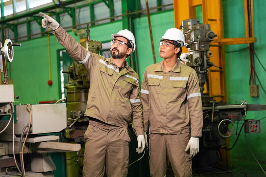 Engineer factory worker hard hat safety industrial machine inspection uniform teamwork adult male female technician manufacturing workshop equipment glove protective helmet production plant