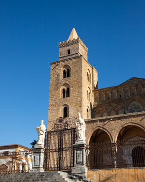 The Norman Cathedral of Cefalu stands majestically with its imposing stone facade.