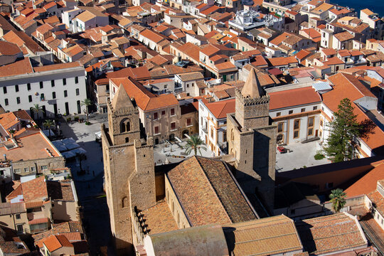 The Norman Cathedral of Cefalu stands majestically with its imposing stone facade.
