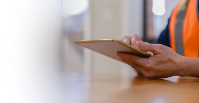 worker using a digital tablet for inventory management and logistics, showcasing smart technology, supply chain operations, stock control, productivity, and modern industrial workflow.