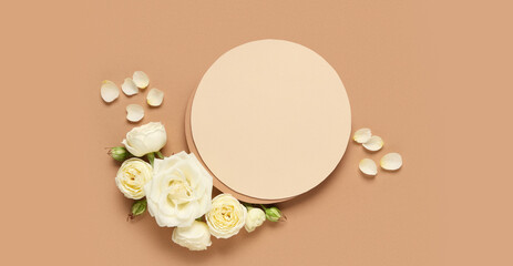 White roses and petals with a blank circular card on a brown background, elegant floral design for invitations and greetings © Pixel-Shot
