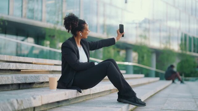 Video call or stream in social media, lady blogger capturing herself and street. Joyful woman sharing video in social media online, modern technology for online communication, phone addicted person