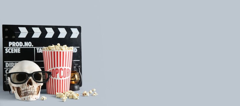 Human skull wearing 3D glasses with popcorn and a clapperboard, horror movie night concept, entertainment and cinema