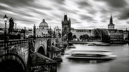 Fototapeta premium Monochrome long exposure landscape of historic bridge and city skyline with river motion and dramatic sky