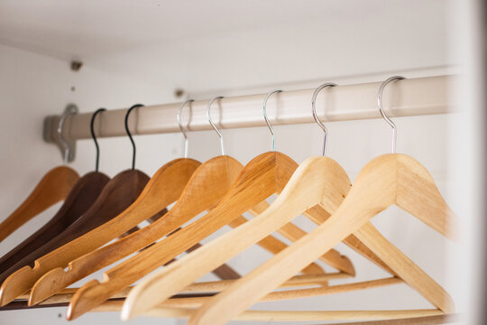 Wooden hangers in empty closet, minimalist setup